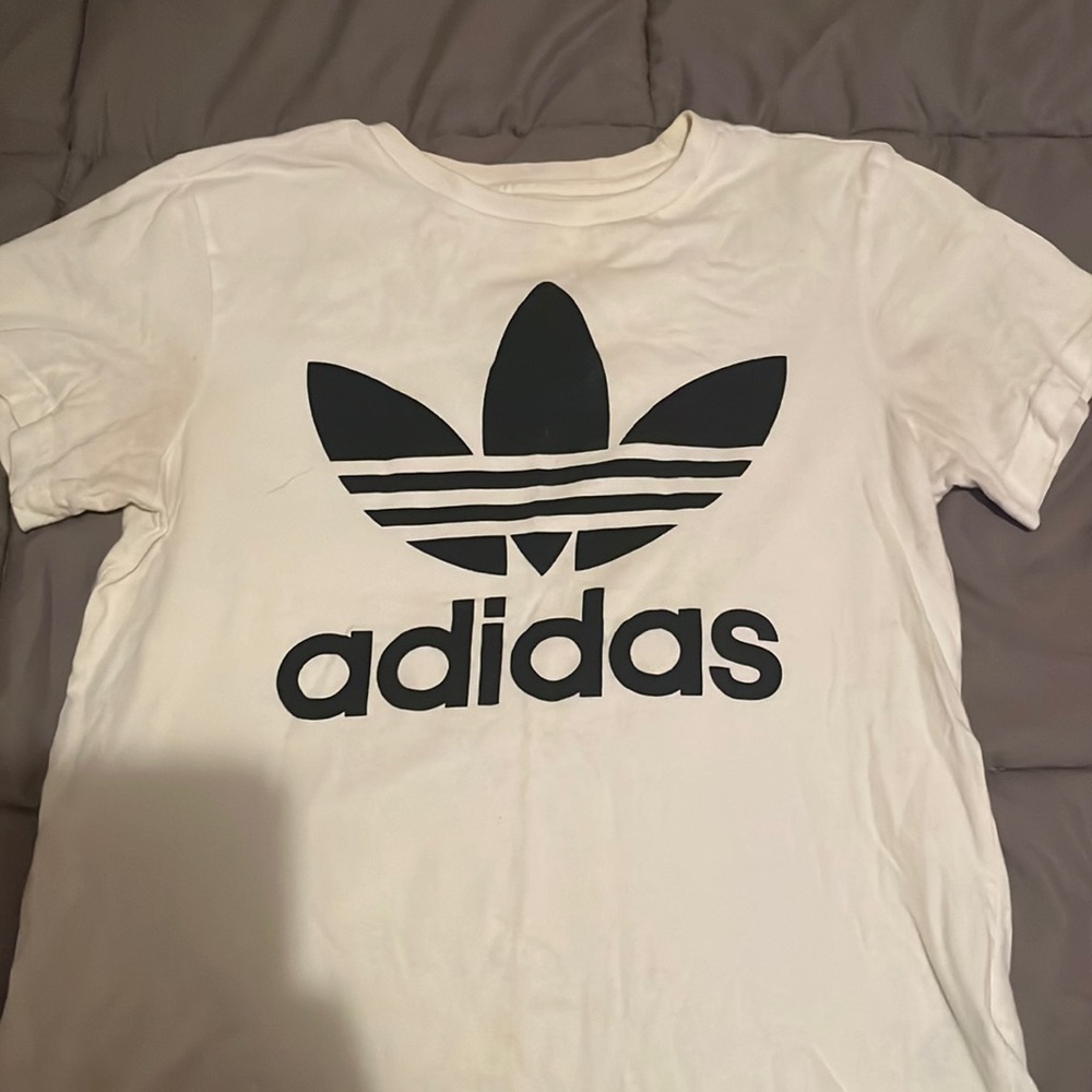 White adidas shirt.